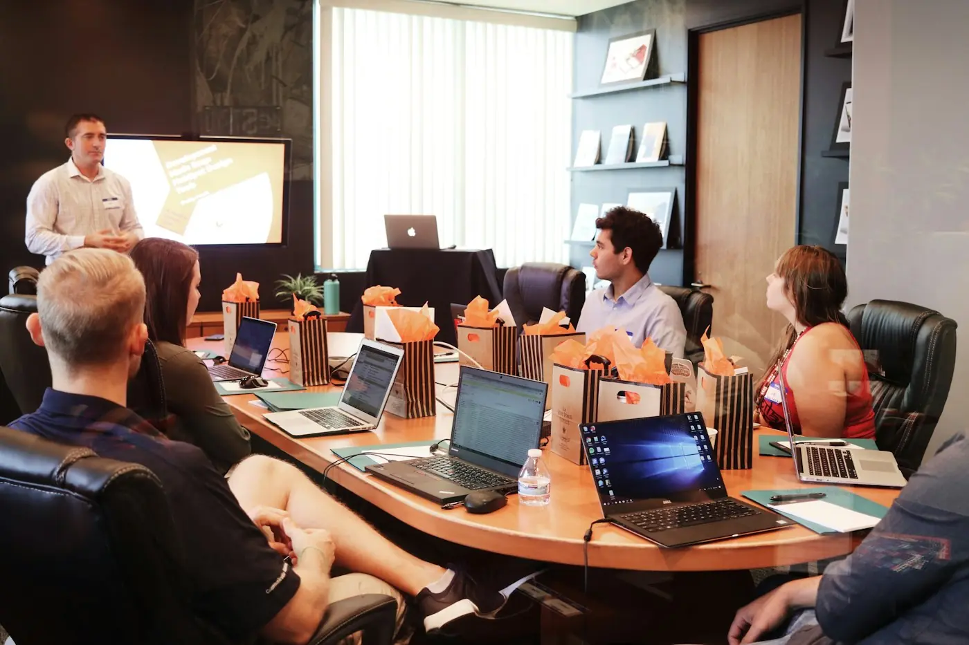 Business team reviewing plans around a boardroom table