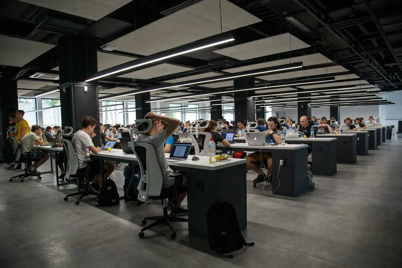 Busy open-plan office with teams working at shared desks