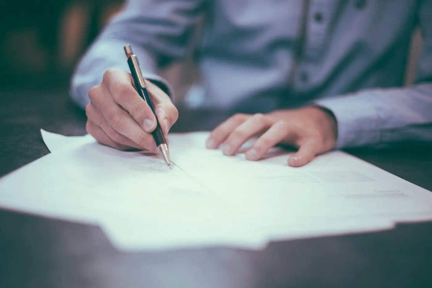 Hands signing business documents