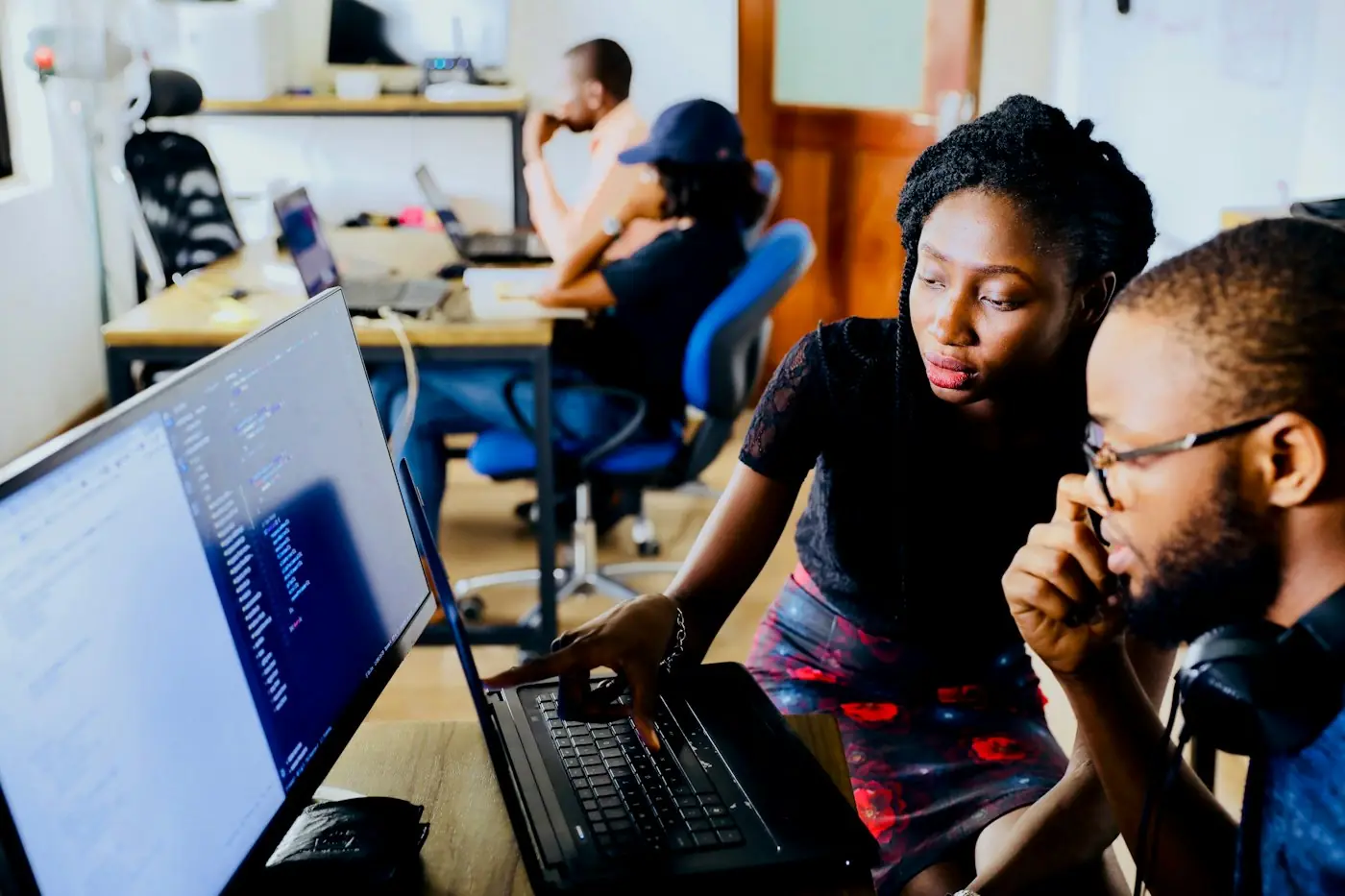 Team reviewing software on a laptop